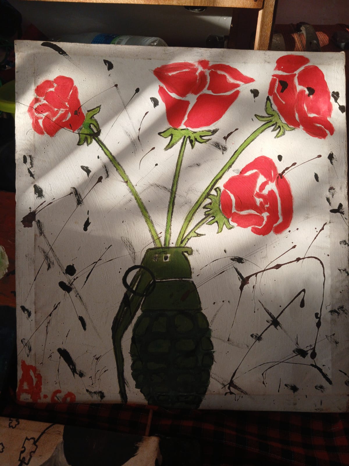 Painting of red roses growing out of a hand grenade on a white background